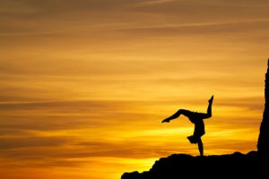 Frau macht Yoga im Sonnenuntergang